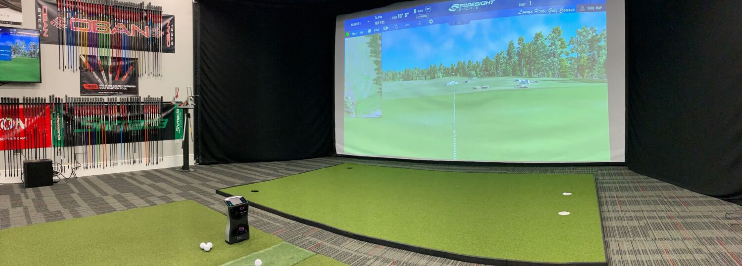 Top Shelf Golf indoor fitting bay with launch monitor and shaft wall