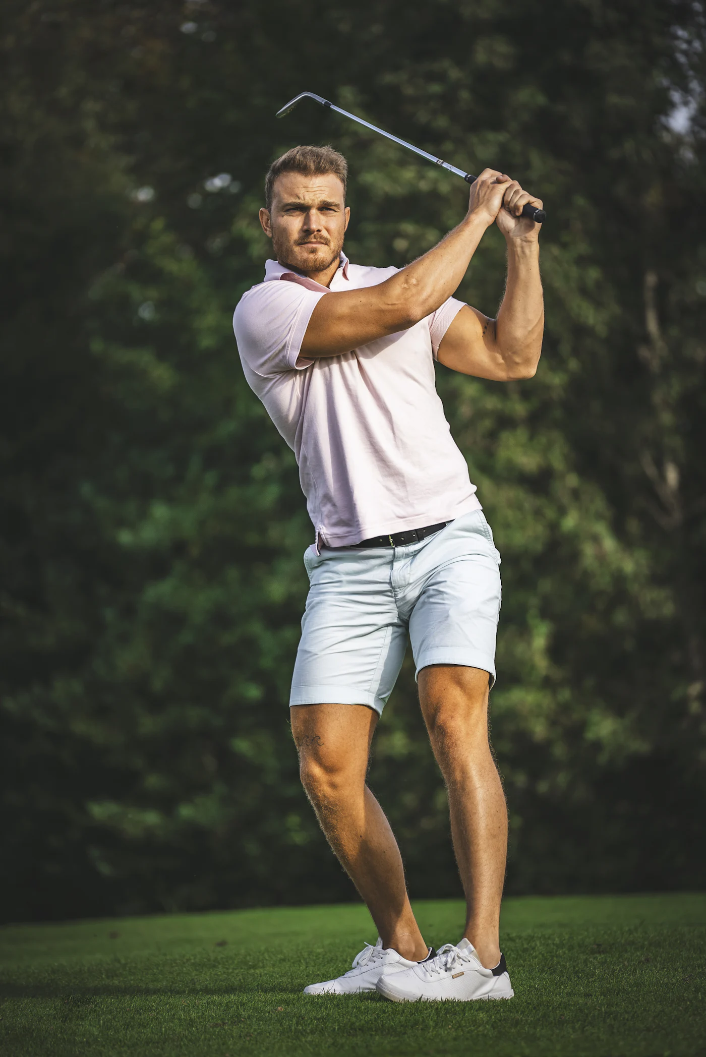 Golf launch monitor positioned beside a player on the range